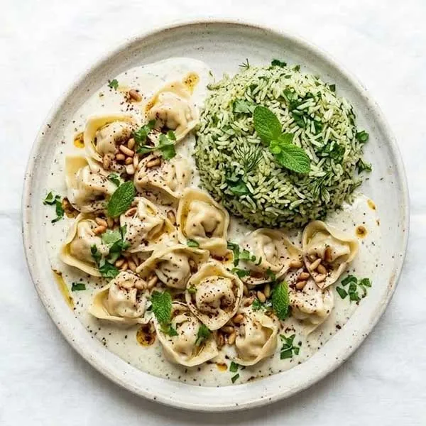 Shish barak chicken dumplings in yogurt sauce with herb rice